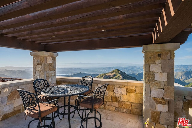 view of terrace featuring a mountain view and a pergola