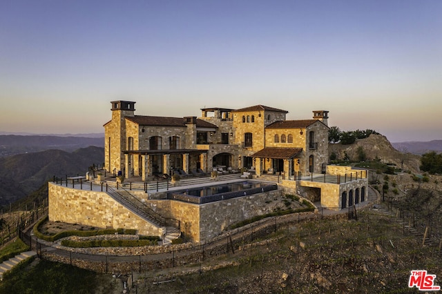 view of back house at dusk