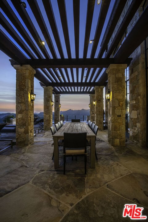 patio terrace at dusk with a pergola