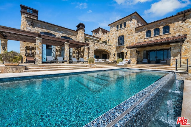 view of swimming pool featuring a patio area and pool water feature