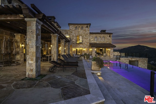 view of patio terrace at dusk