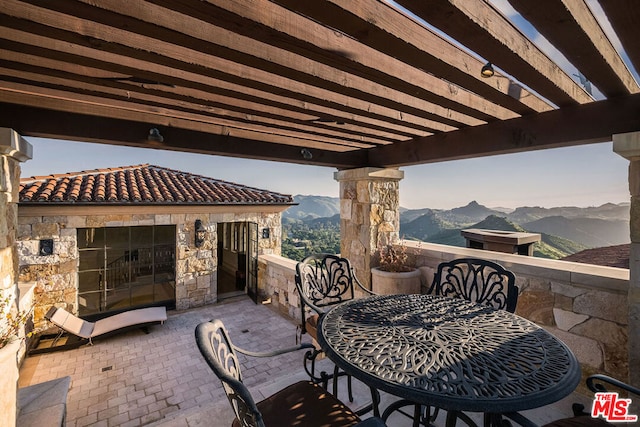 view of patio / terrace featuring a mountain view and a pergola