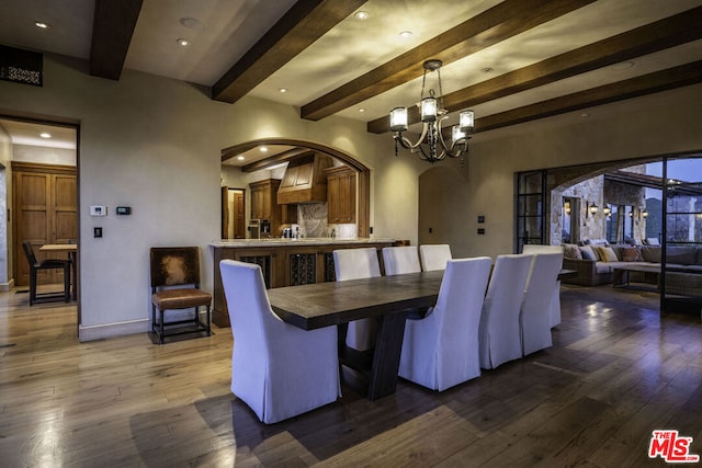 dining room with beam ceiling, wood-type flooring, and an inviting chandelier