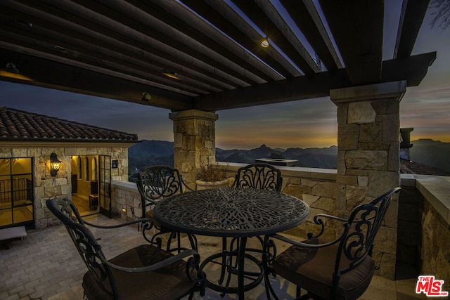 patio terrace at dusk with a mountain view