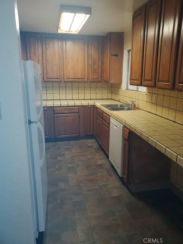 kitchen with white appliances, tile countertops, tasteful backsplash, and sink