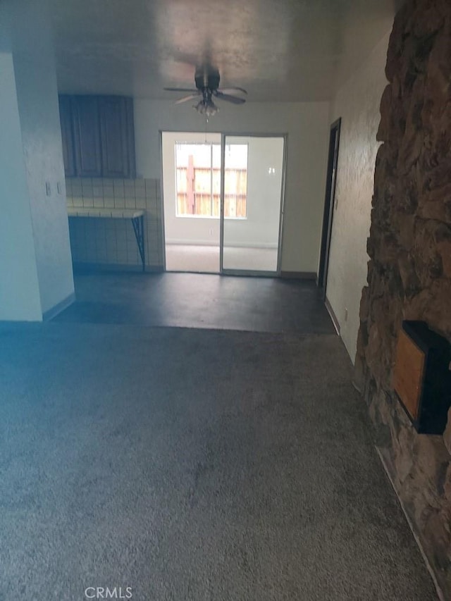 unfurnished living room featuring ceiling fan