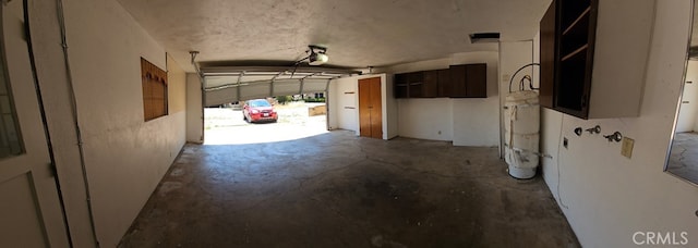 garage with a garage door opener and water heater