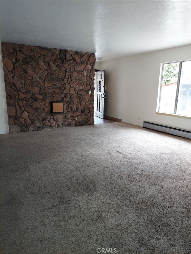 unfurnished living room with carpet flooring and baseboard heating