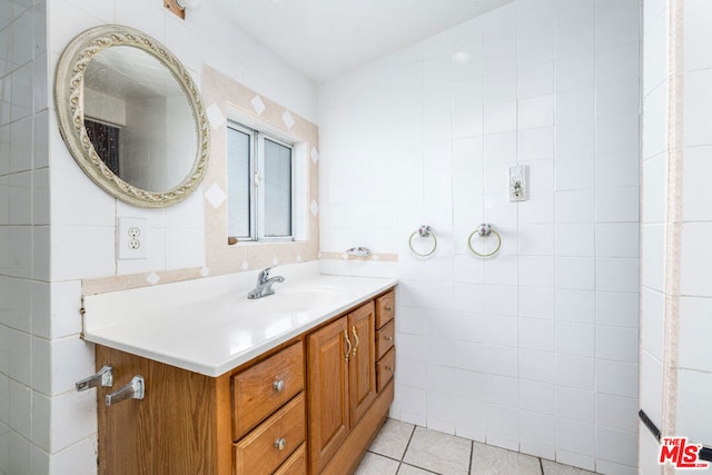 bathroom with tile walls, tile floors, and vanity