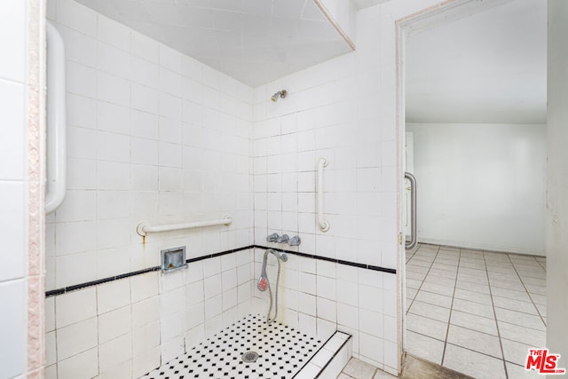 bathroom featuring a tile shower and tile flooring