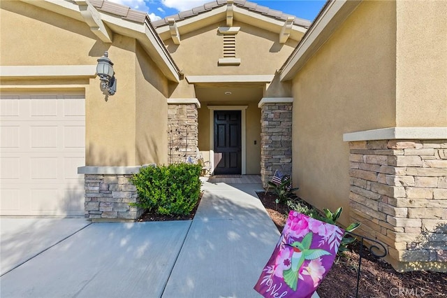 view of exterior entry with a garage