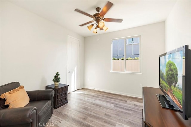 sitting room featuring ceiling fan and light hardwood / wood-style flooring