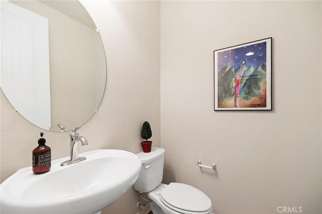 bathroom featuring sink and toilet