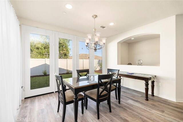 dining room featuring hardwood / wood-style flooring and a chandelier