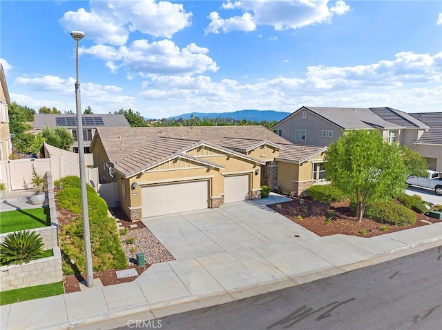 view of front of home with a garage and a mountain view