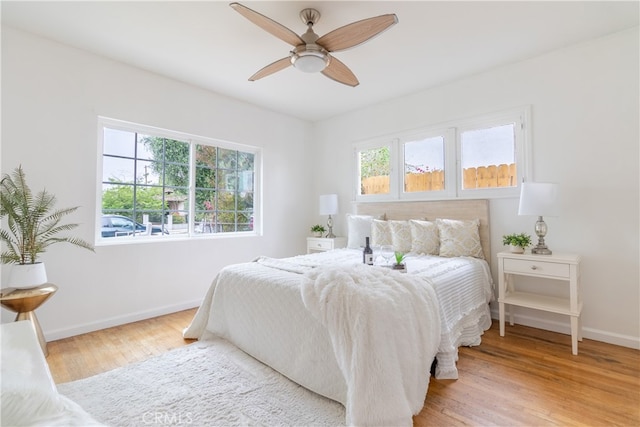 bedroom with light hardwood / wood-style floors and ceiling fan