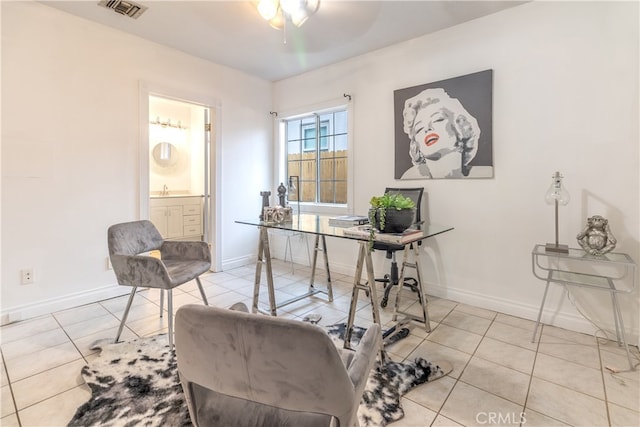 tiled home office featuring ceiling fan