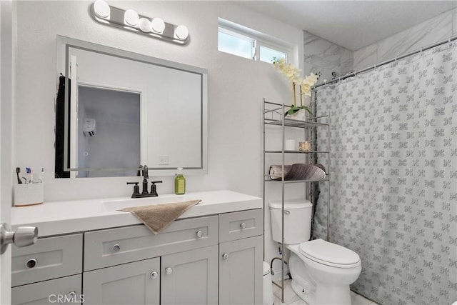 bathroom with vanity, toilet, and walk in shower