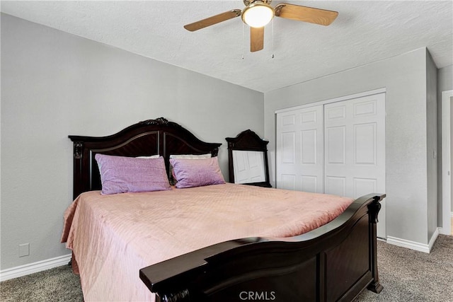 carpeted bedroom featuring ceiling fan, a closet, and a textured ceiling