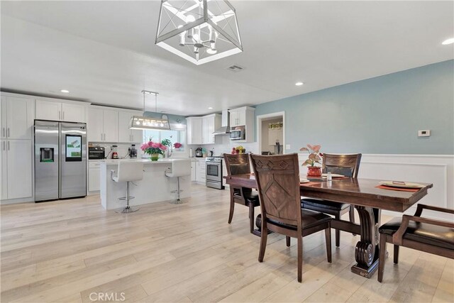 dining area with light hardwood / wood-style floors