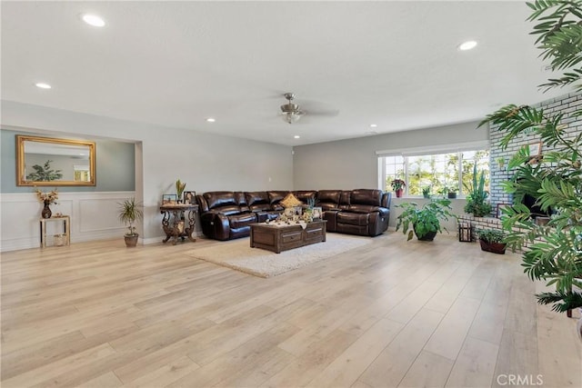 living room with ceiling fan and light wood-type flooring