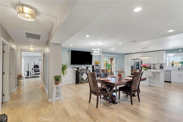 dining space with light hardwood / wood-style flooring