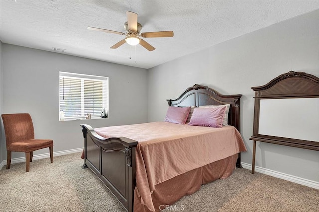 bedroom with a textured ceiling, ceiling fan, and light carpet