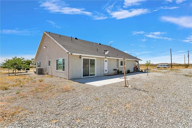 back of property with a patio area and central AC