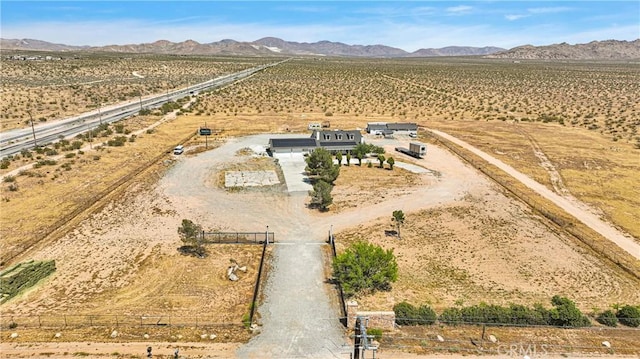 birds eye view of property featuring a mountain view and a rural view