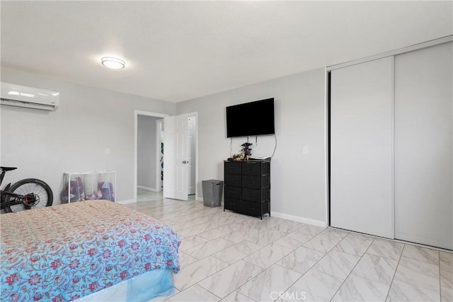 bedroom featuring an AC wall unit and a closet