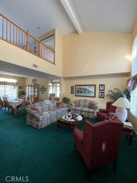 carpeted living room featuring beamed ceiling, high vaulted ceiling, and plenty of natural light