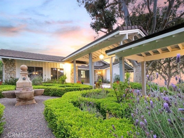 view of back house at dusk