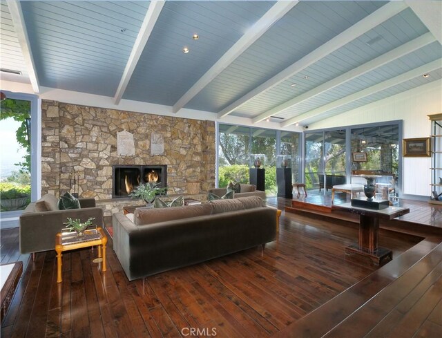 living room with lofted ceiling with beams, a fireplace, and dark hardwood / wood-style floors