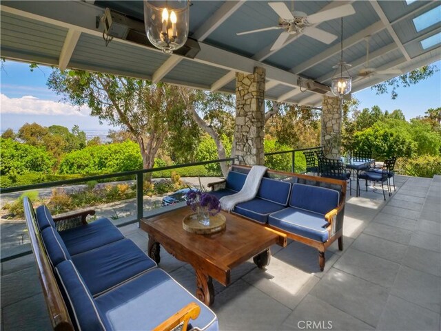 view of patio / terrace with ceiling fan and an outdoor living space