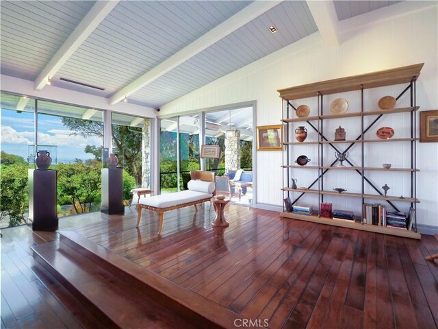 interior space with a healthy amount of sunlight and lofted ceiling with beams