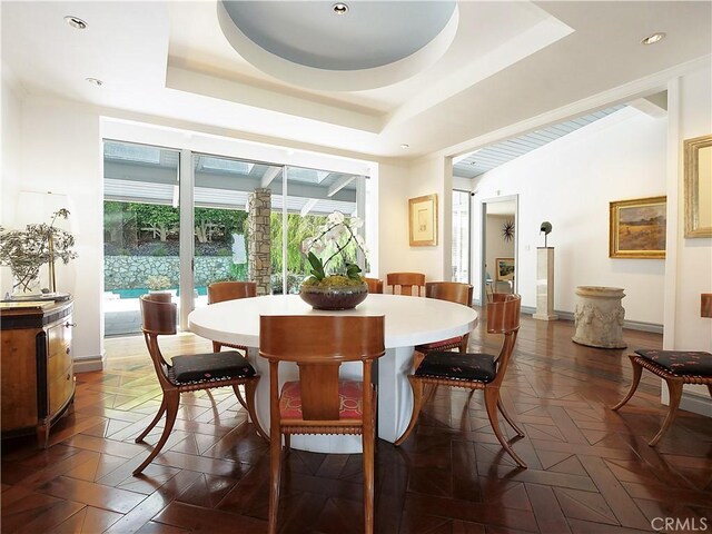 dining space featuring a raised ceiling