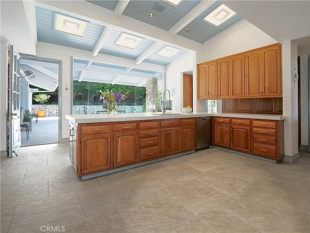 kitchen featuring vaulted ceiling with beams, kitchen peninsula, dishwasher, and sink