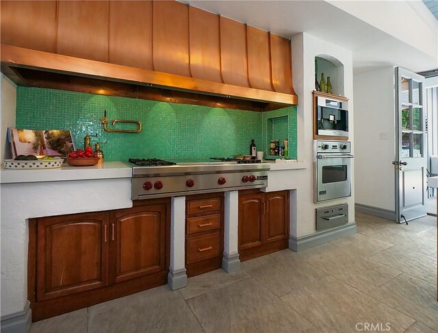 kitchen featuring stainless steel appliances and decorative backsplash