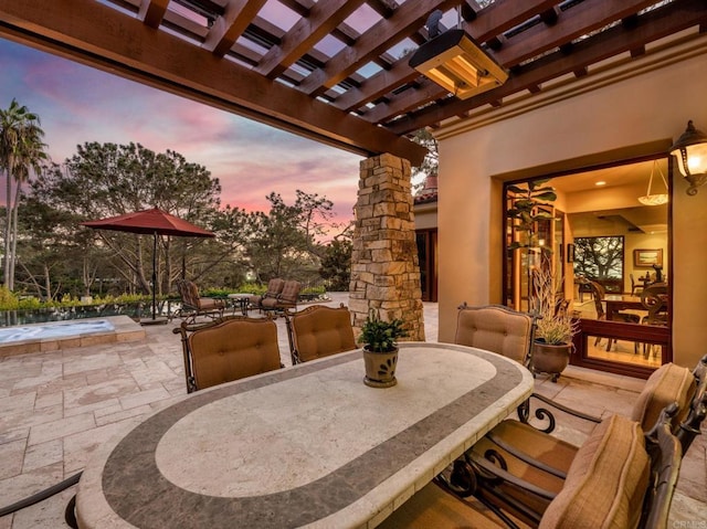 patio terrace at dusk with a pergola