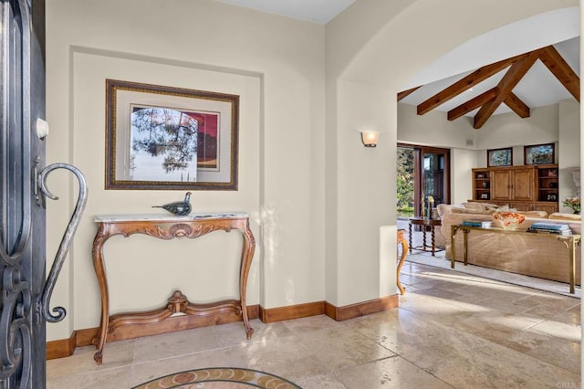 interior space featuring vaulted ceiling with beams