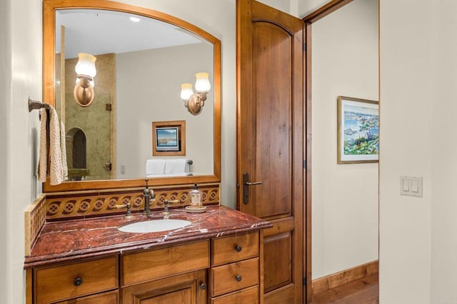 bathroom with vanity and hardwood / wood-style floors