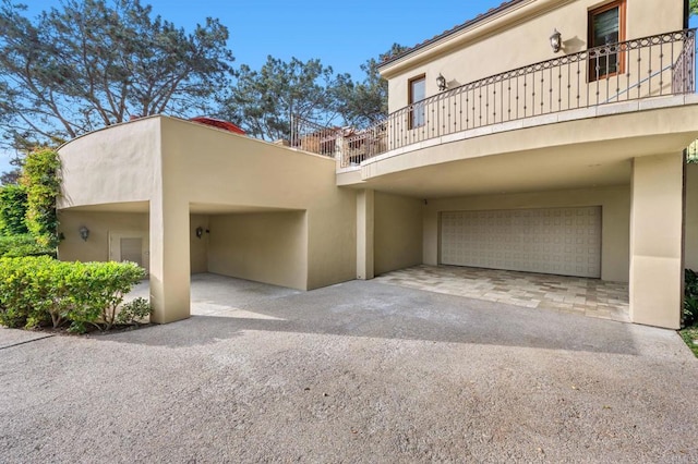 exterior space featuring a balcony and a garage