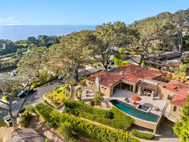 birds eye view of property with a water view