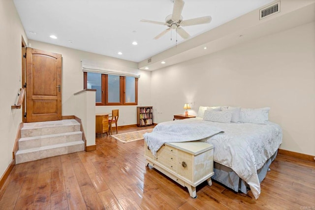 bedroom with light hardwood / wood-style floors and ceiling fan