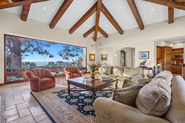 living room featuring beam ceiling and high vaulted ceiling