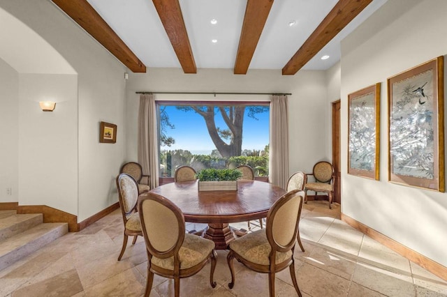 dining area with beam ceiling