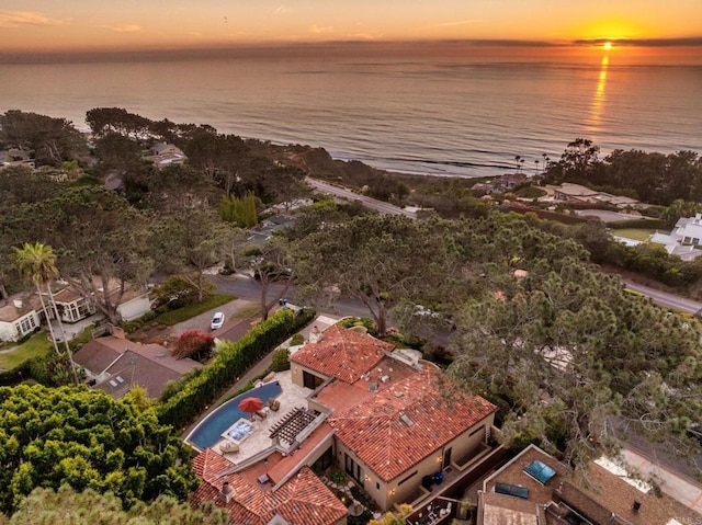 aerial view at dusk with a water view