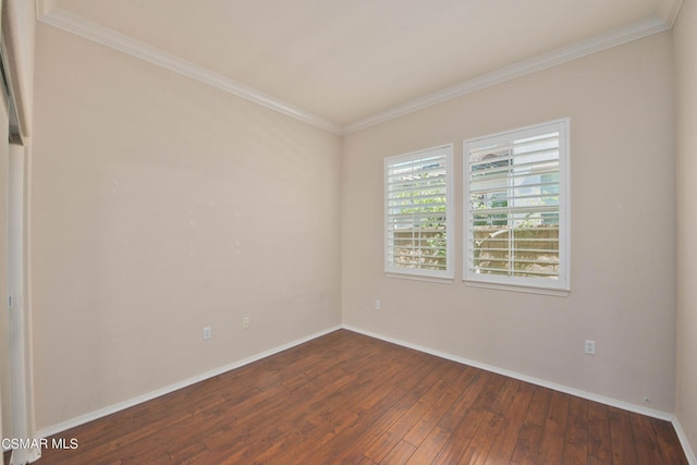 empty room with ornamental molding and hardwood / wood-style floors