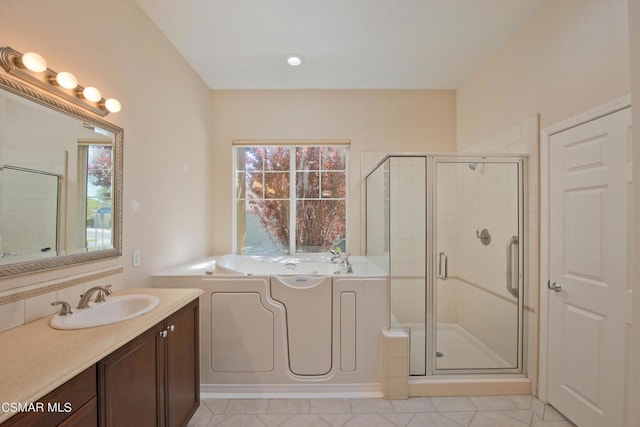 bathroom with tile flooring, vanity, and plus walk in shower