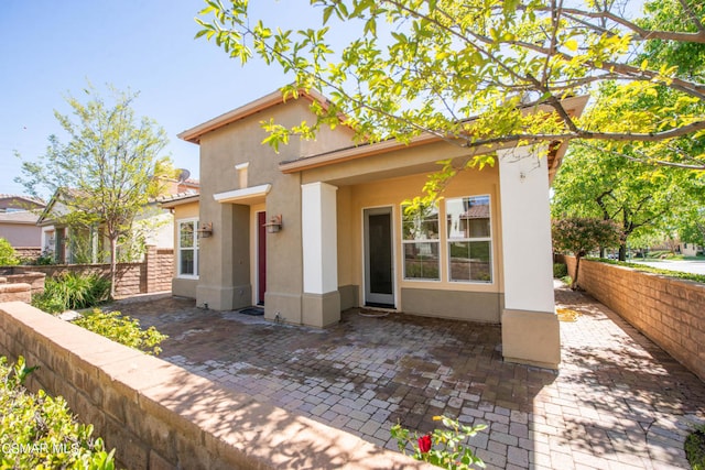 rear view of property featuring a patio